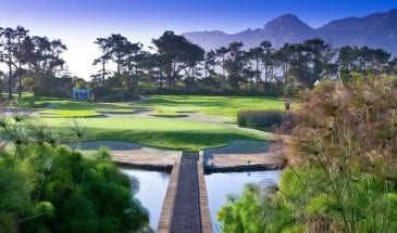 Steenberg Golf Club, terrain de golf dans la région du Cap avec un arrière plan de montagnes.